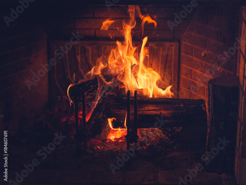 Burning wood in fireplace in a countryside house