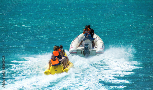 El Gouna/Egypt - April 11, 2015: Sea attraction, happy people ride the inflatable watercraft boat