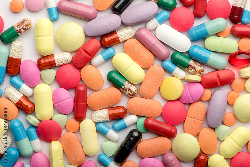 Multicolored pills on white background. Multicolored pills on white background.
