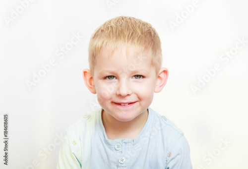 Happy childhood. Portrait of smiling blond boy child kid indoor