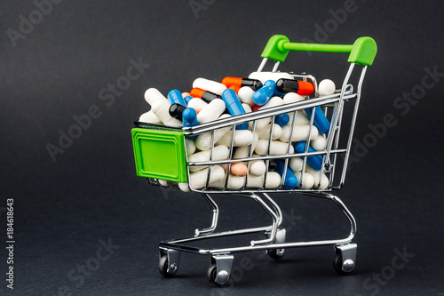 Small shopping cart full of pills.