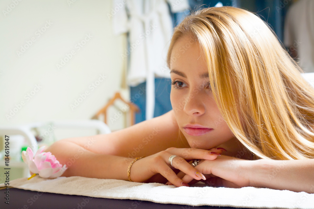 Obraz premium Beautiful young woman receiving massage in spa salon