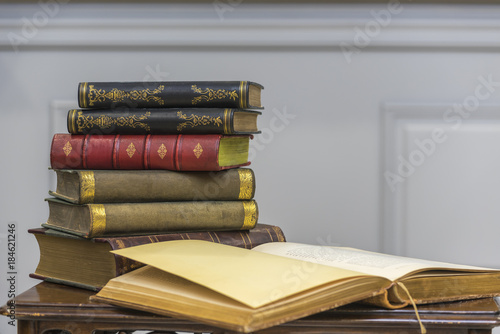 A stack of old books on the coffee table. photo