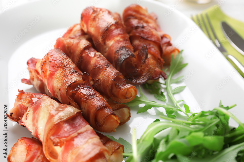 Plate with bacon wrapped chicken nuggets, closeup Plate with bacon wrapped chicken nuggets, closeup