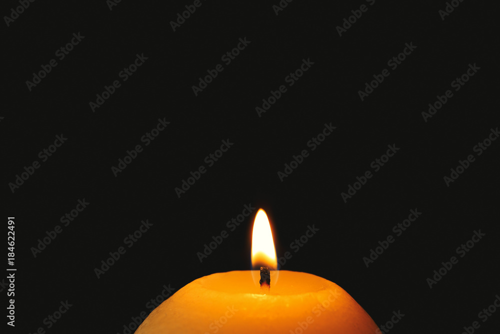 Wax candle burning in darkness, closeup Wax candle burning in darkness, closeup