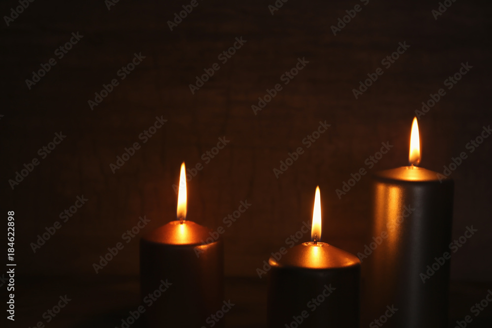 Burning candles on dark background Burning candles on dark background