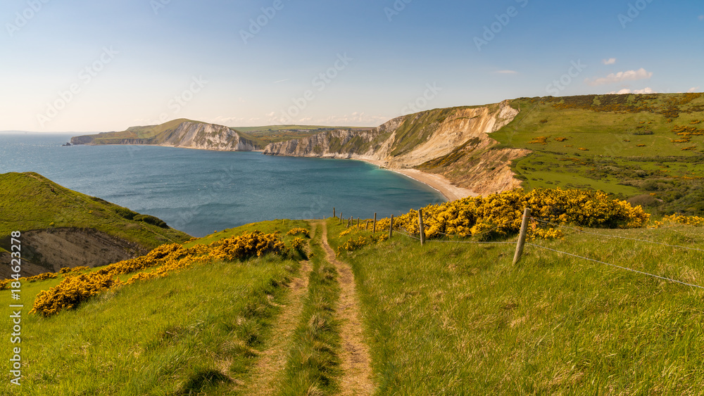Walking on the South West Coast Path, looking at Worbarrow Bay, near Tyneham, Jurassic Coast, Dorset, UK Walking on the South West Coast Path, looking at Worbarrow Bay, near Tyneham, Jurassic Coast, Dorset, UK