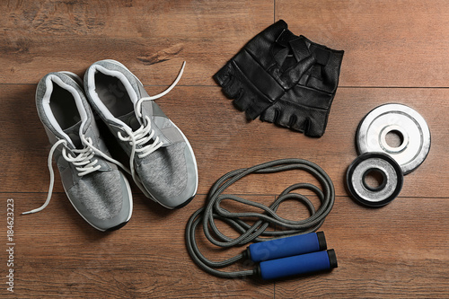 Composition with jumping rope on wooden background