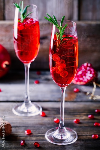 Pomegranate champagne mimosa cocktail with rosemary