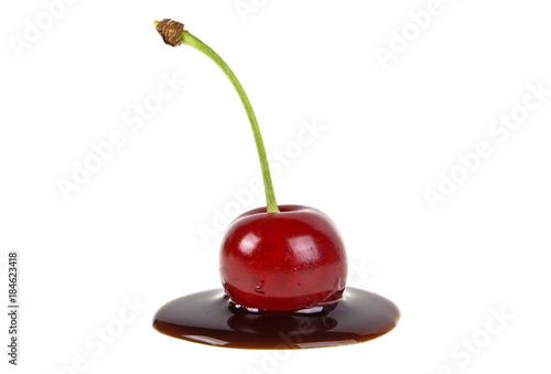 Liquid chocolate and cherry on a white background