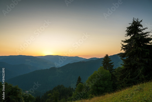 Panoramic view of colorful sunrise in mountains.