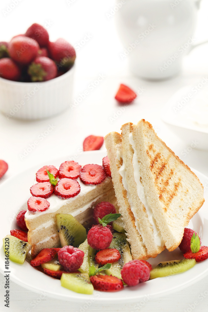 Toasts bread with various berries on white wooden table Toasts bread with various berries on white wooden table