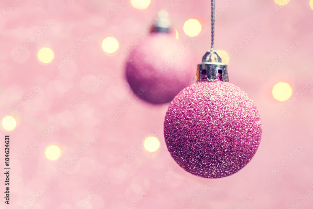 Photo of two Christmas pink balls on pink background with spots. Photo of two Christmas pink balls on pink background with spots.