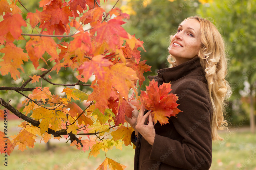 Joyful woman dreams under an autumn tree Joyful woman dreams under an autumn tree
