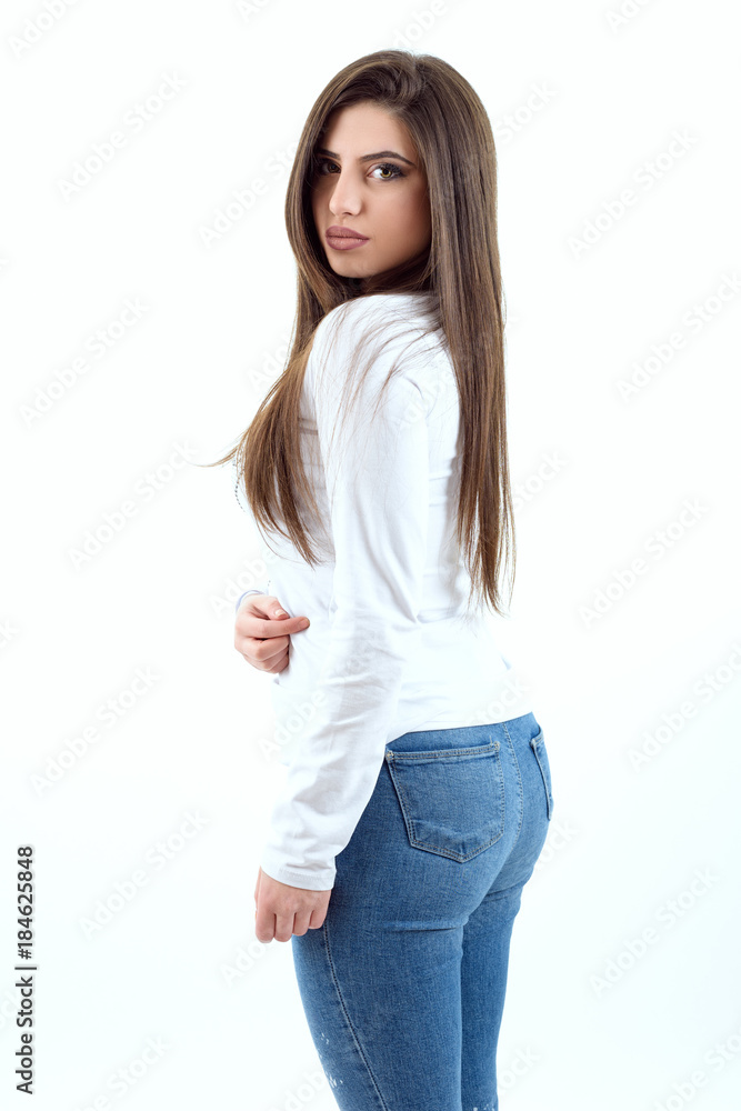 Beautiful young girl wearing a jeans and white t-shirt Stock Photo | Adobe  Stock