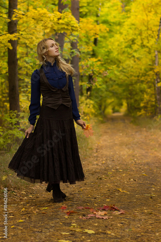 Pretty woman on a walk in the autumn forest