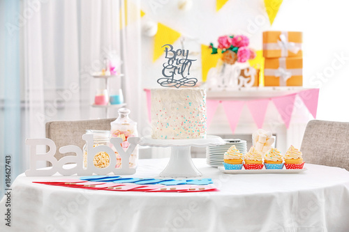 "Boy or girl" cake and "Thank you" cards for baby shower party on table indoors © Africa Studio