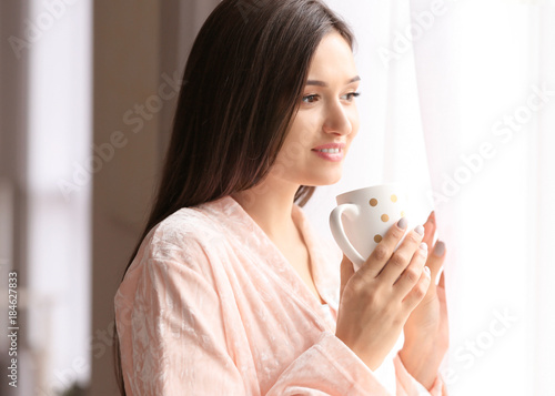 Young woman drinking coffee...
