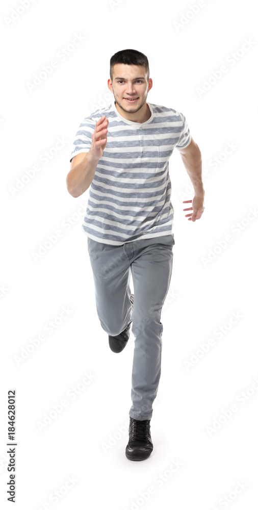 Young man in casual clothes running against white background Young man in casual clothes running against white background
