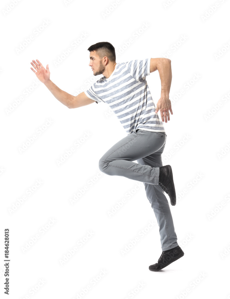 Young man in casual clothes running against white background Young man in casual clothes running against white background