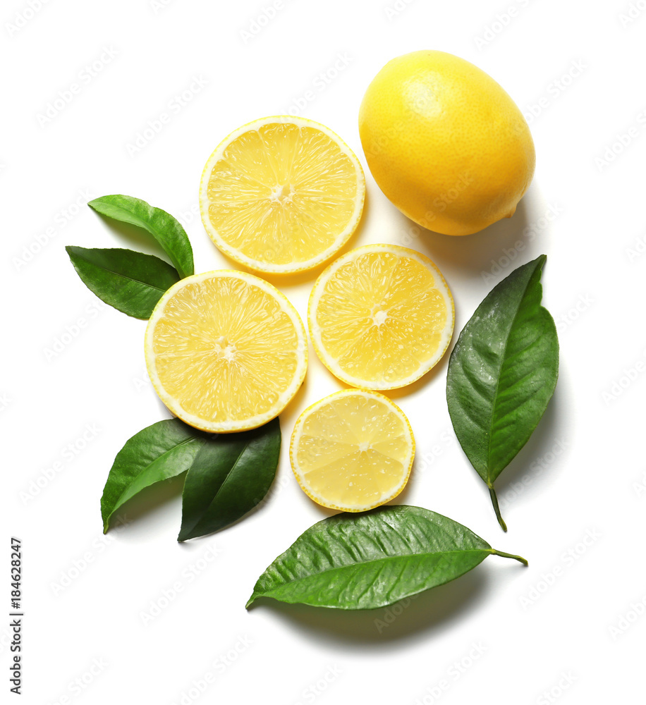 Composition with lemon and green leaves on white background Composition with lemon and green leaves on white background