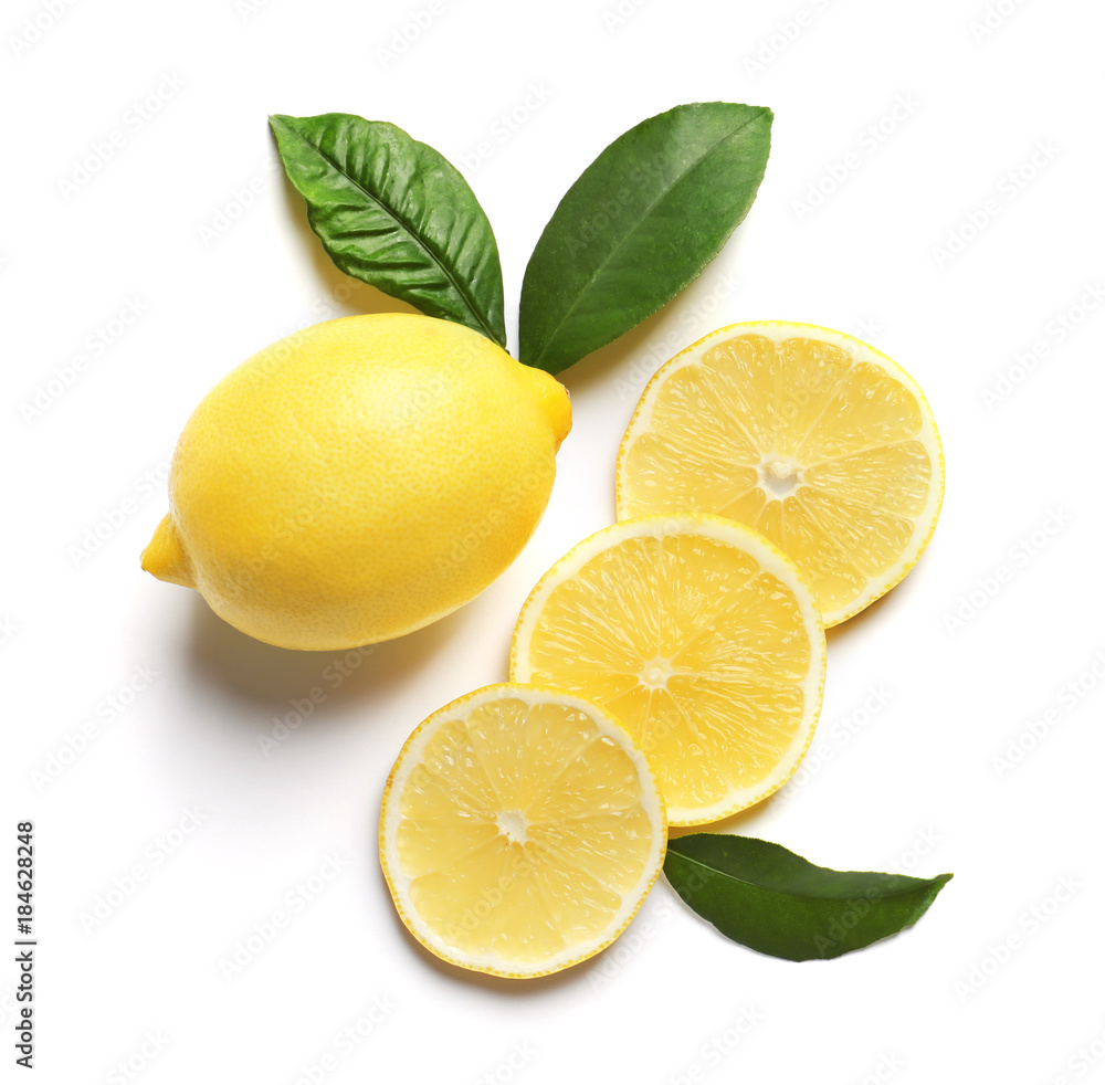Composition with lemon and green leaves on white background