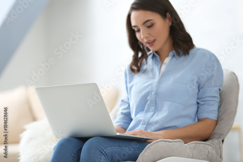 Young woman using laptop at home