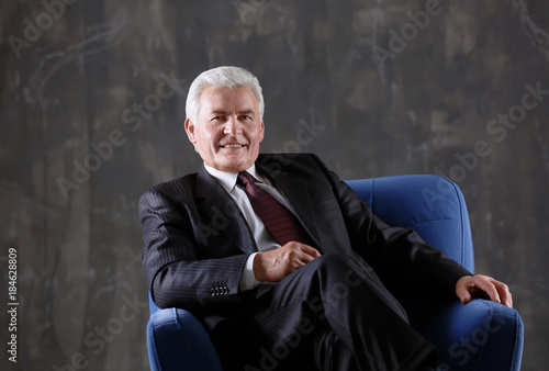 Handsome mature man sitting...