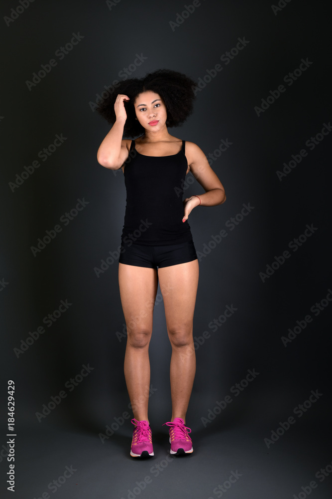 Young black woman with afro hairstyle smiling. Young black woman with afro hairstyle smiling.