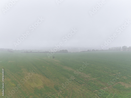 View over misty rural fields. Typical view in Czech Republic countryside.