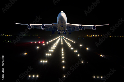 Passenger aircraft takes off from the night airport runway