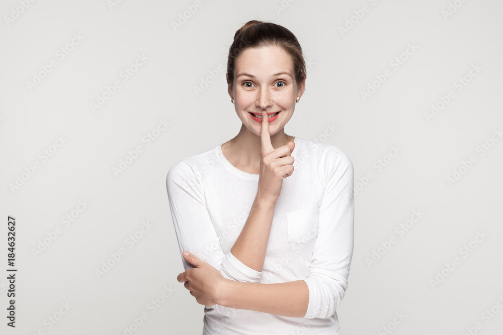 Shocked young woman, showing shh sing Shocked young woman, showing shh sing