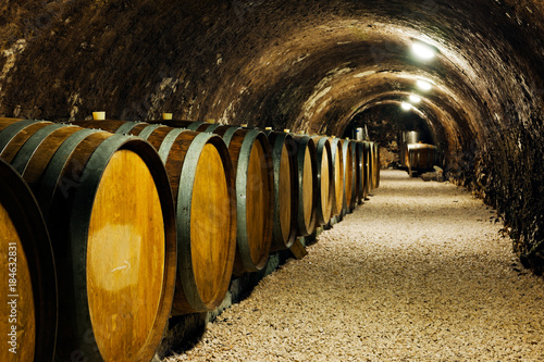 Old wine barrels in a wine cellar photo