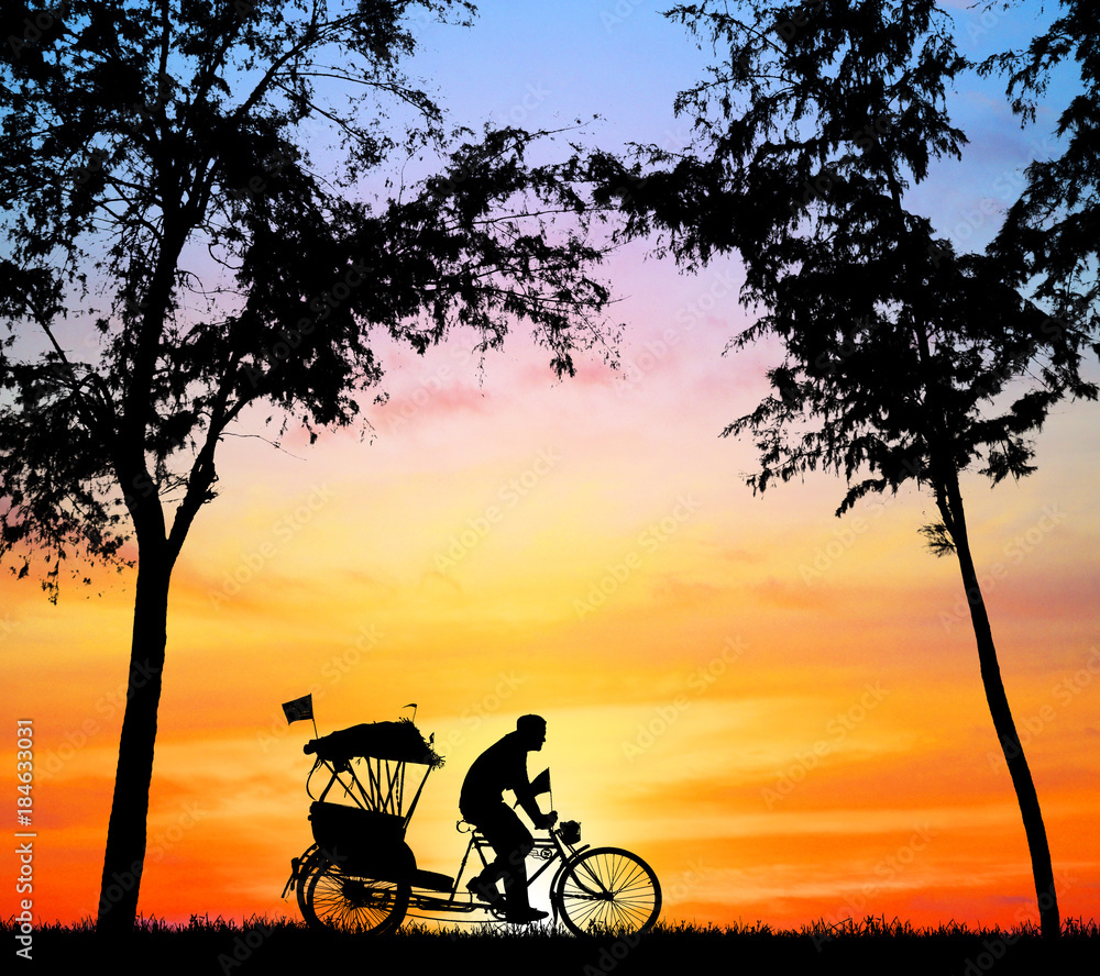 silhouette old man ride Tricycle on colorful sky background