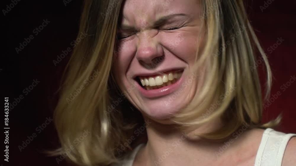 The blonde chews something that frowns on the taste, slow motion The blonde chews something that frowns on the taste, slow motion