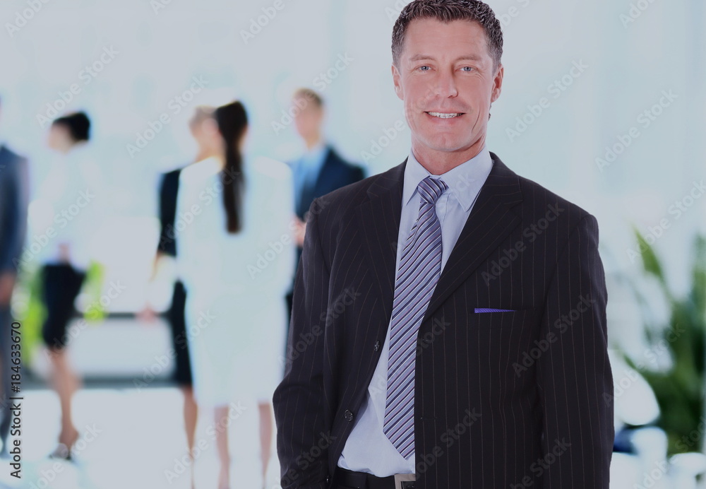 Happy mature business man looking at camera with satisfaction at office Happy mature business man looking at camera with satisfaction at office