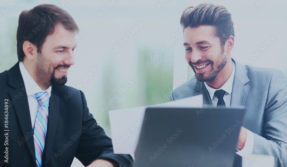 Business men discussing together in an office Business men discussing together in an office