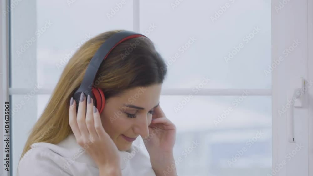 Charming blonde in headphones enjoy of lisening music Charming blonde in headphones enjoy of lisening music