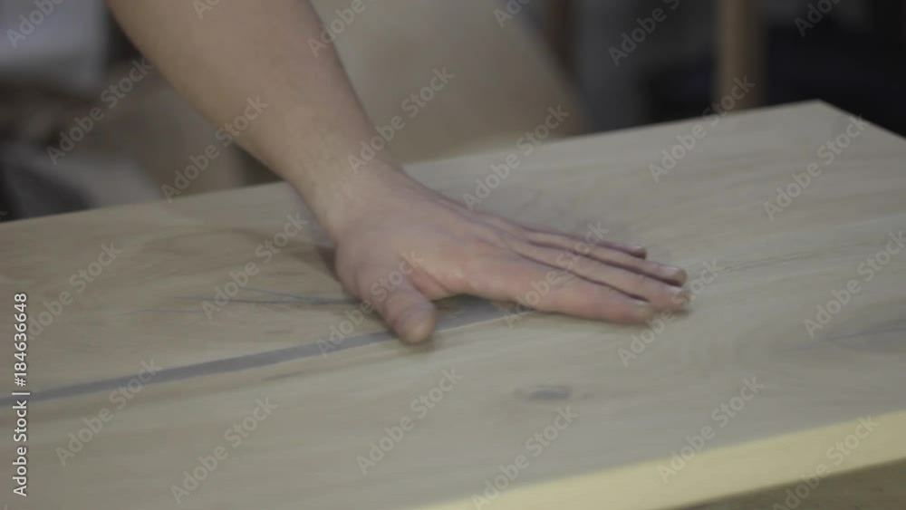 woodworker grinds and finishing the countertop of oak woodworker grinds and finishing the countertop of oak
