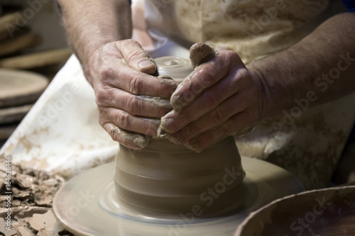Hands of ceramic artist making a piece