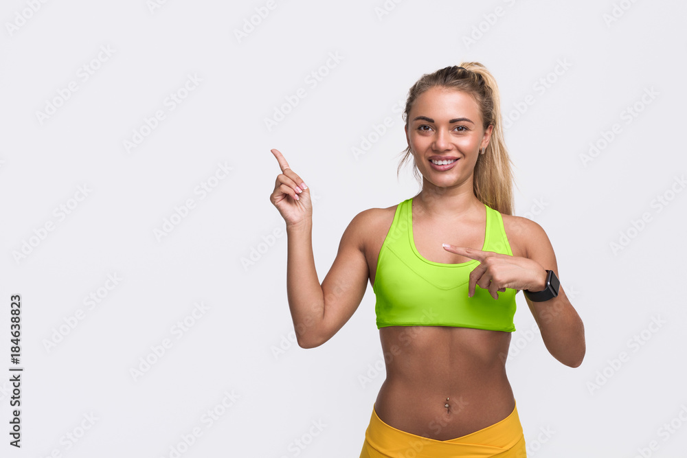 Smiling woman pointing at empty space Smiling woman pointing at empty space