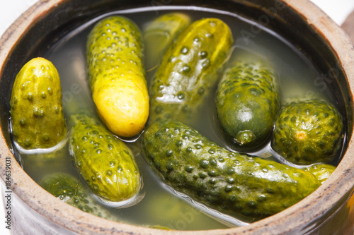 Fresh homemade pickled cucumbers in clay pot