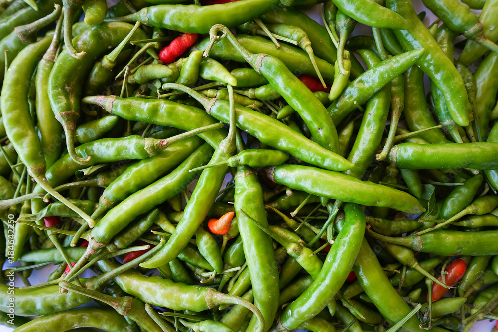 Top view red green chili pepper ingredient for Tom Yum Chili hot spicy soup thai food on wooden background Top view red green chili pepper ingredient for Tom Yum Chili hot spicy soup thai food on wooden background