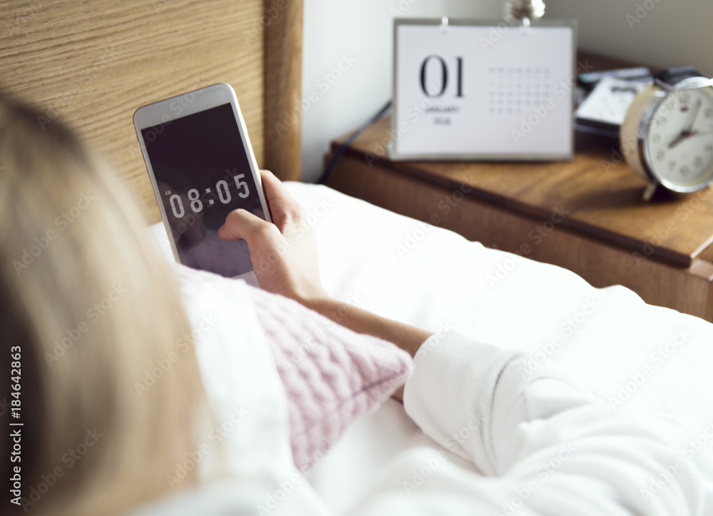 An awake woman checking her mobile phone An awake woman checking her mobile phone