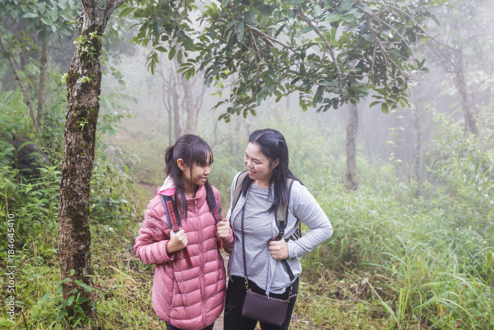 Asia girl Mother and daughter backpack behind go hiking or climbing in Nature Mountain. Asia girl Mother and daughter backpack behind go hiking or climbing in Nature Mountain.