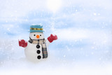 Happy snowman is standing in winter christmas landscape