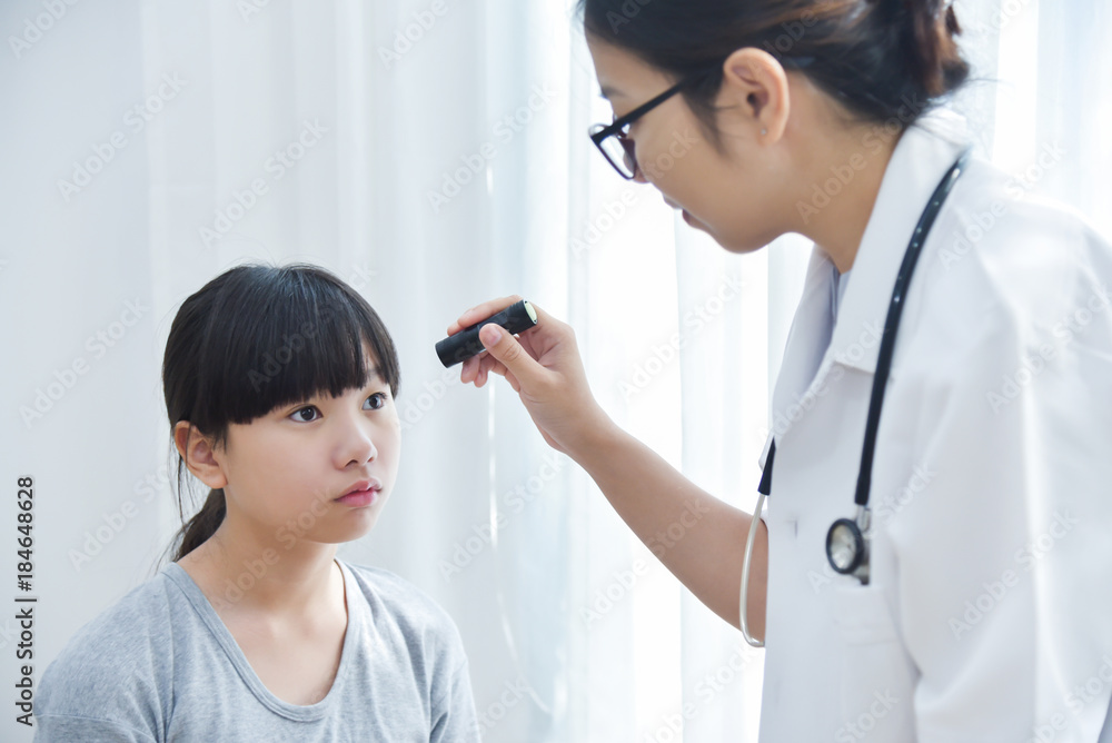 Doctor wear glasses checking a little girl patient eyes. Doctor wear glasses checking a little girl patient eyes.
