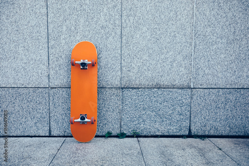 one skateboard against gray wall photo