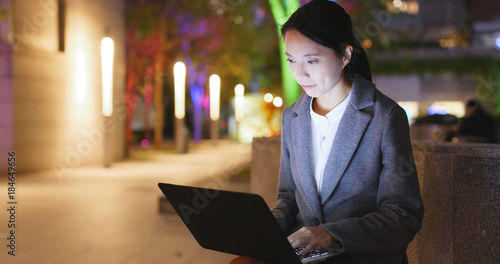 Photography Business woman work on notebook computer at night