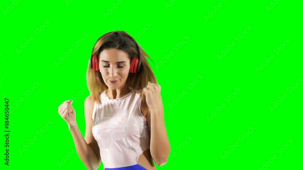 Pretty blonde dancing to music at green background Pretty blonde dancing to music at green background